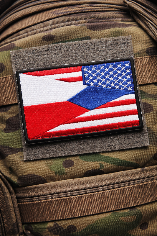 An embroidered patch of a czech and american flag on a military rucksack